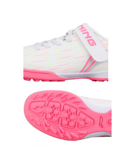 White youth turf shoe with pink sole, side profile and studded outsole close-up