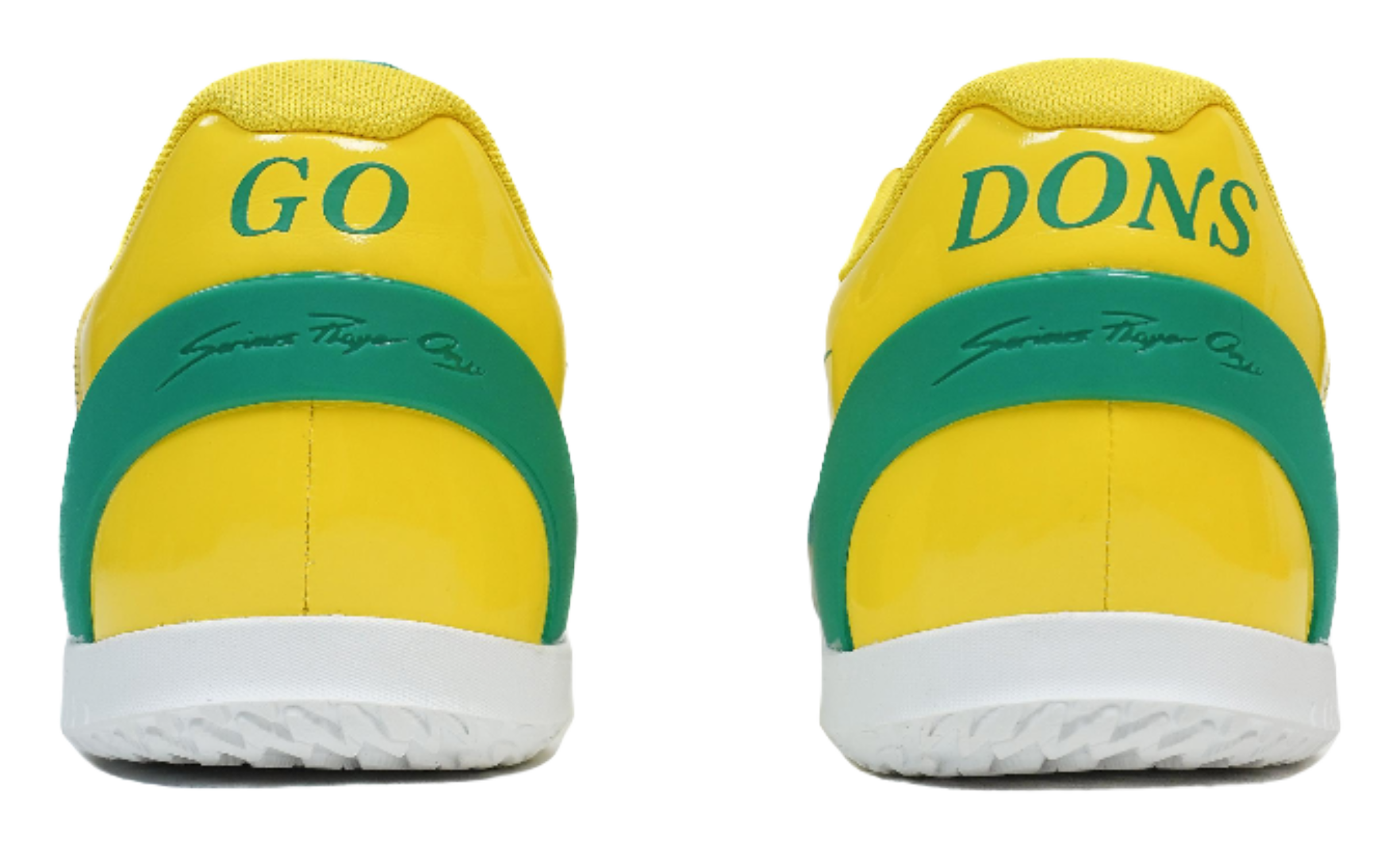 Rear view of yellow basketball shoes with green heel tabs marked "Go Dons"