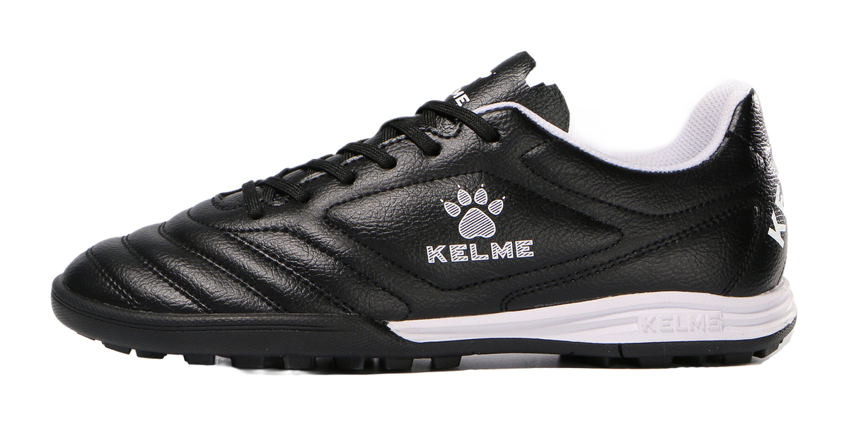 Black TF training soccer shoe with lace-up, KELME logo, and white midsole