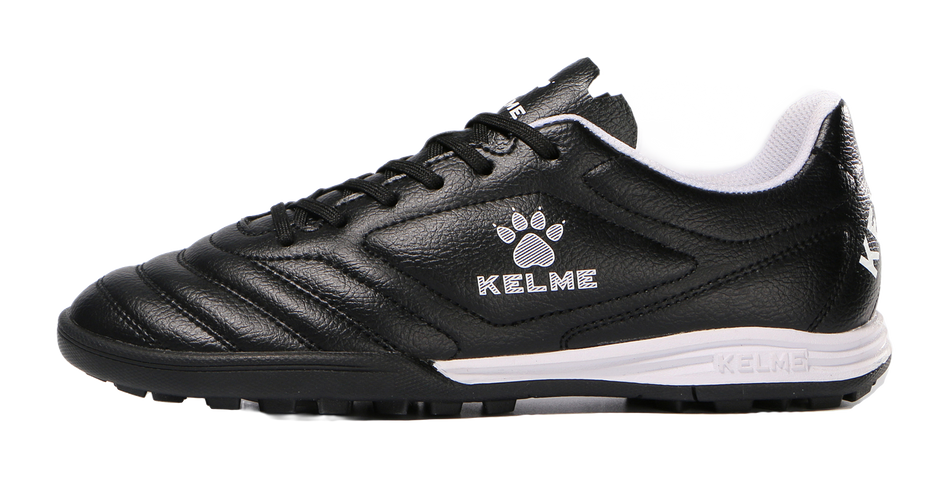 Black TF training soccer shoe with lace-up, KELME logo, and white midsole