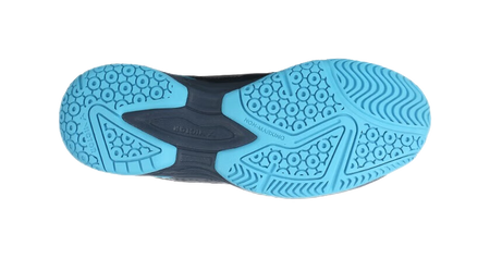Badminton shoe outsole view with blue traction pattern and dark midsole edge.