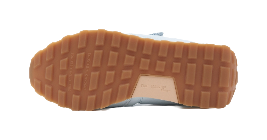 Outsole view of light sky blue low-top Mary Jane sneakers with textured gum tread