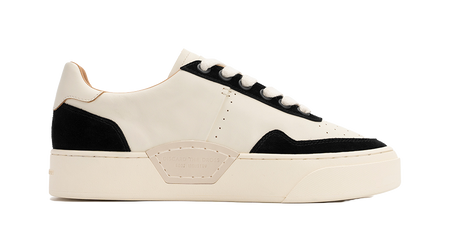 Low-top skate shoes, off-white and black side panels, lace-up, cushioned platform sole.
