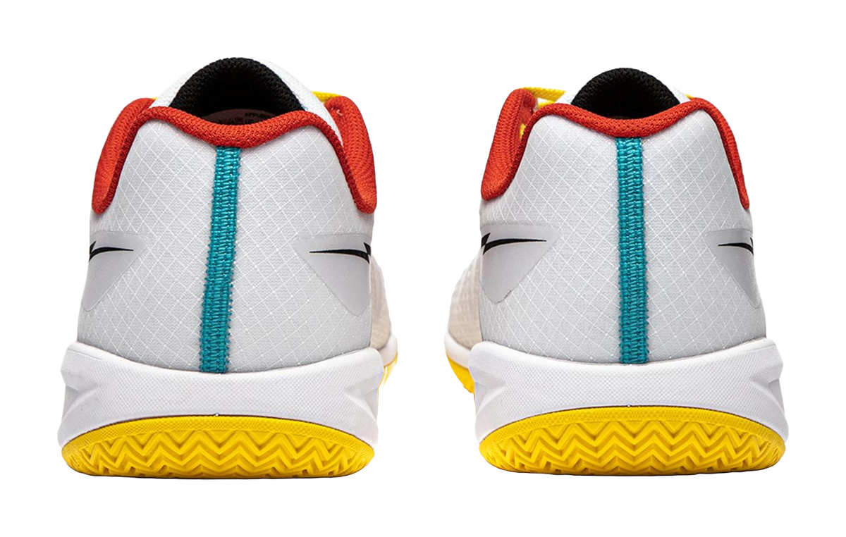 Pair of white table tennis shoes showing heels, red collars, teal strap, yellow outsole