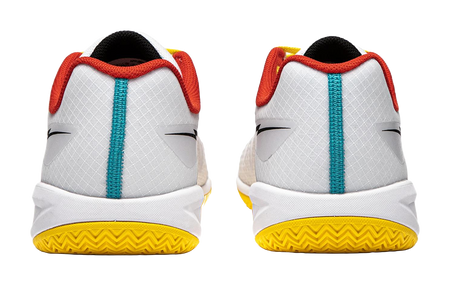 Pair of white table tennis shoes showing heels, red collars, teal strap, yellow outsole