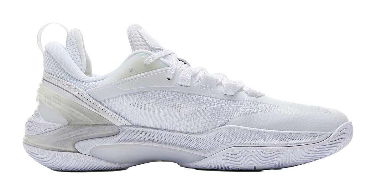 White and silver basketball shoe with textured knit upper, side panel, and cushioned midsole