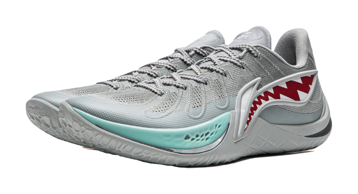 Gray basketball shoe with teal trim, red shark graphic, and laces