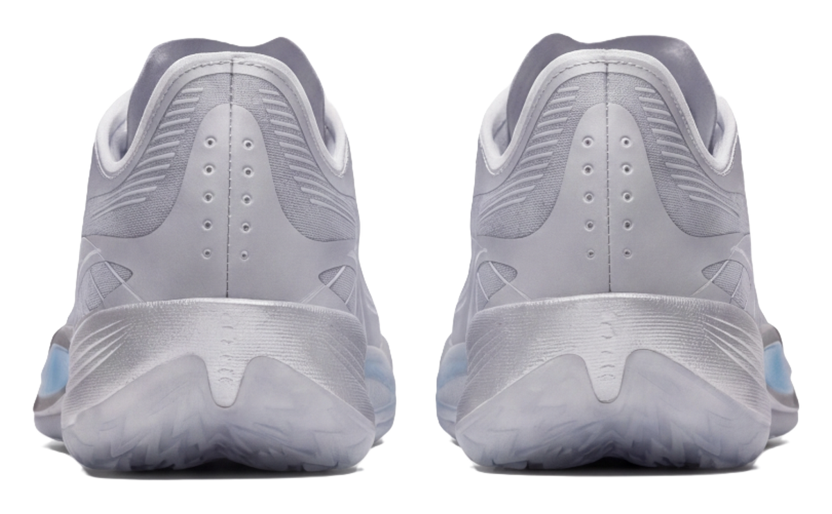 Silver low-top basketball shoes, back view, perforated heel and lace eyelets