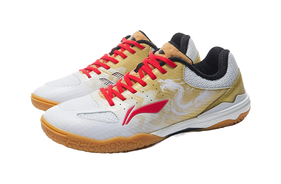 White and gold table tennis shoe with red laces and black collar, front angle view.