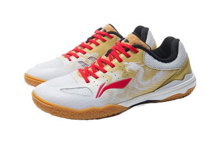 White and gold table tennis shoe with red laces and black collar, front angle view.
