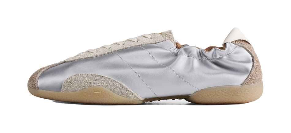 Low-top silver sneakers with beige suede side panels and off-white lace trim