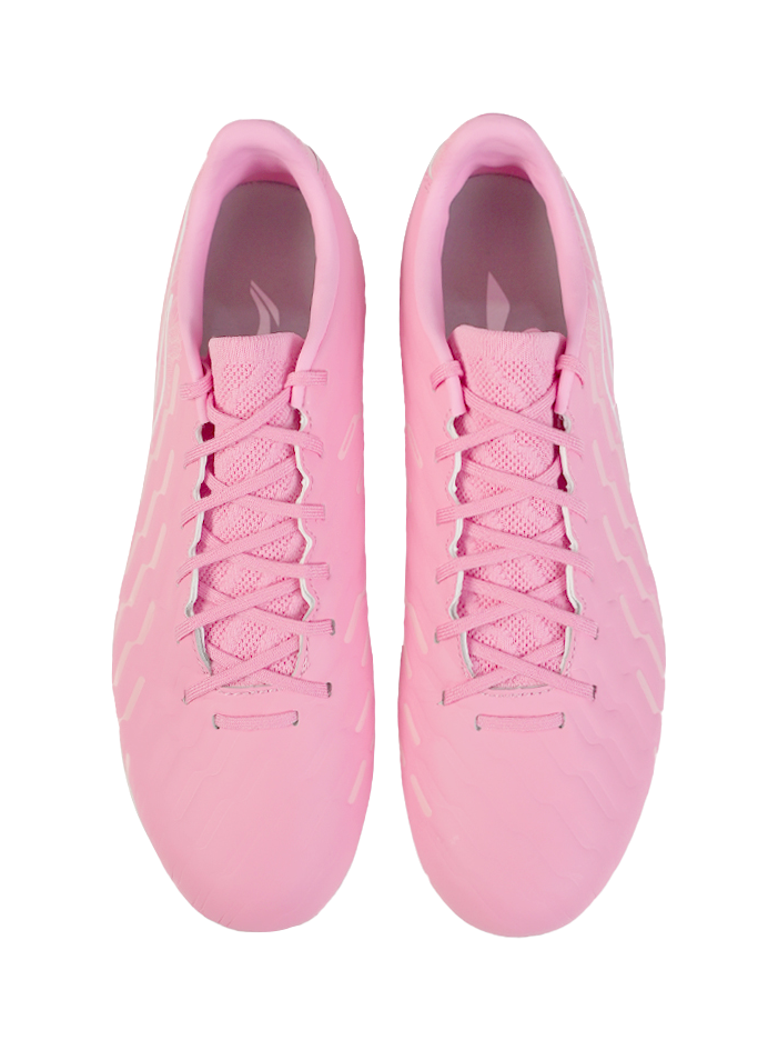 Pair of pink soccer cleats, front view showing lace-up tongues and rounded studs