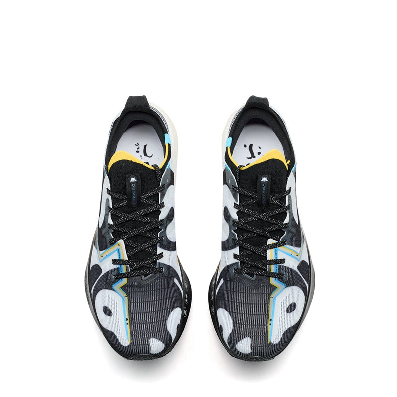 Marathon racing shoe pair view, black upper with white graphics, yellow collar lining