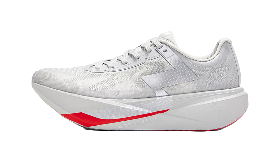 Gray low-top running shoe with lace-up front, textured upper, red/gray sole