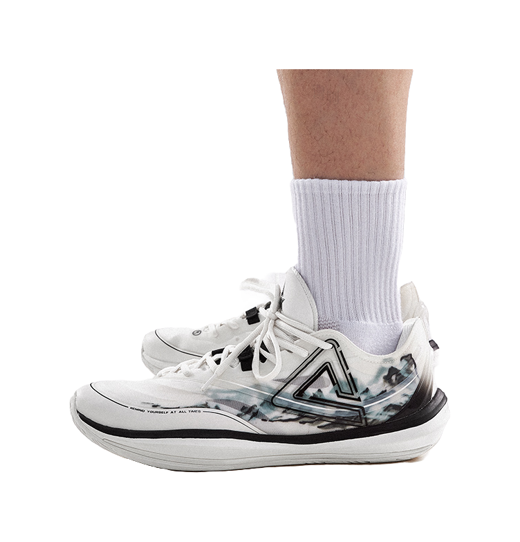 Lightweight basketball shoe on ankle, cream upper with black trim and blue-gray graphic