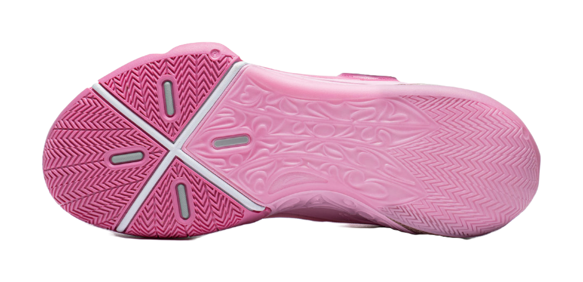 Pink basketball sneaker outsole view with X-shaped traction pattern