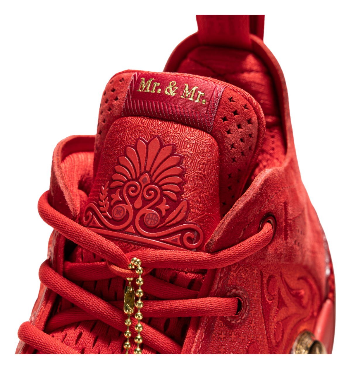Red tongue and heel area with embroidered pattern and gold lace charm.