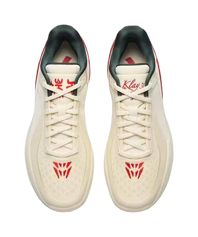 Beige basketball shoes pair, red logo on tongue and laces, lace-up low-top.