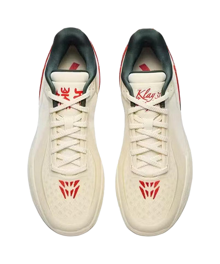Beige basketball shoes pair, red logo on tongue and laces, lace-up low-top.