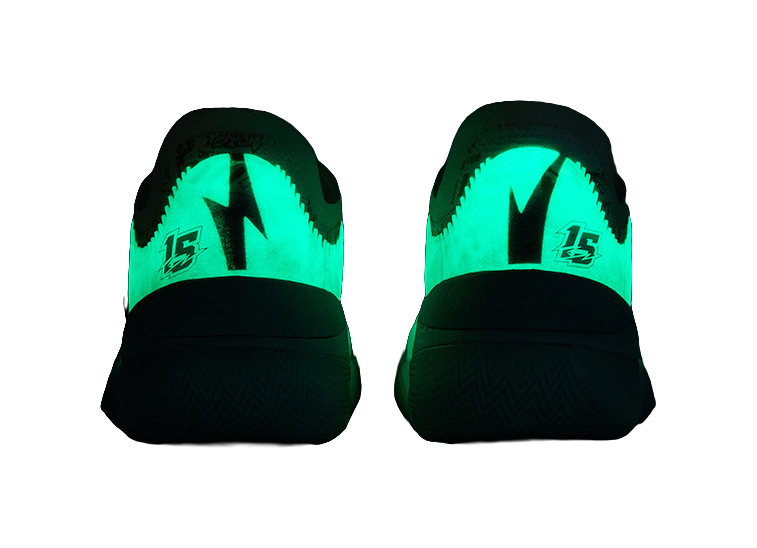 Neon-green lighted basketball shoe heels with black midsole and traction pattern