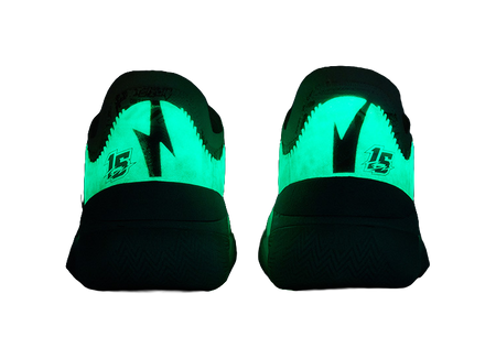 Neon-green lighted basketball shoe heels with black midsole and traction pattern