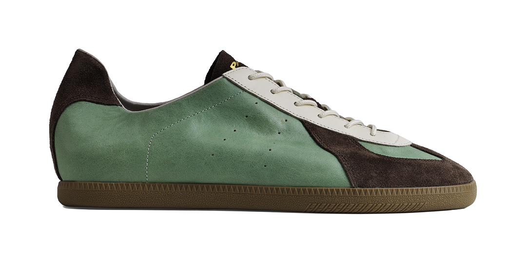 Mint low-top lace-up shoe with dark side panels and textured rubber sole