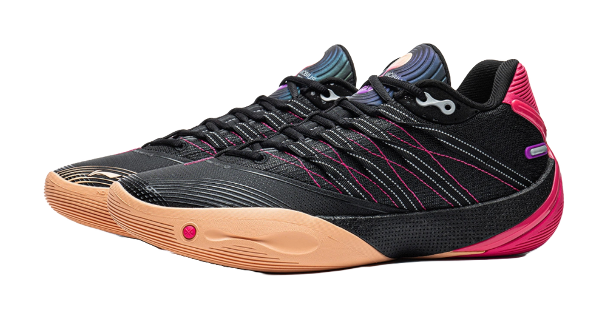Low basketball shoe side view: black knit upper, pink heel, gum sole, lace-up.