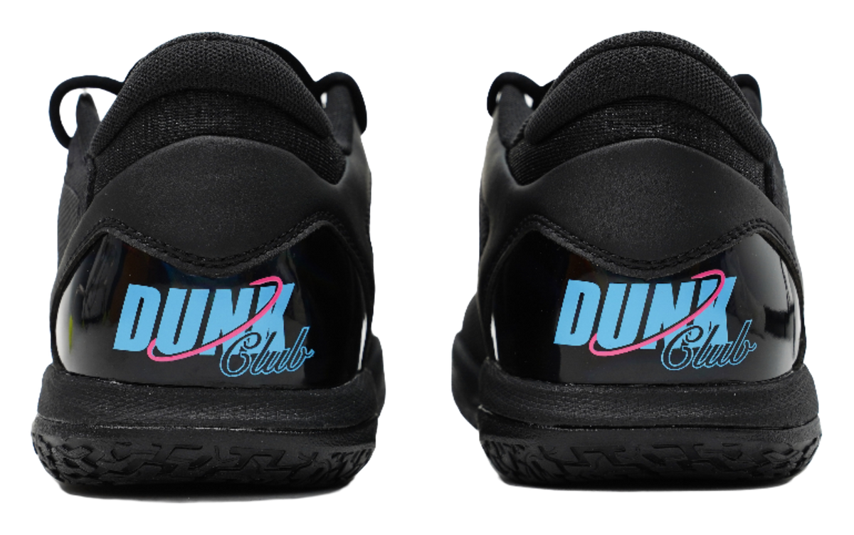 Black low-top basketball shoes with blue heel logo and pink trim detail.