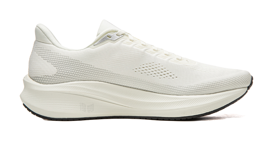White unisex running shoe, side view with breathable mesh upper and lace-up closure.