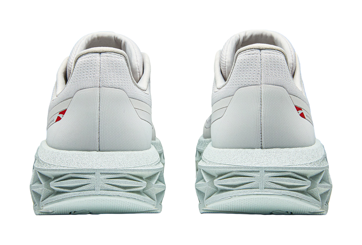 Pair of Anta low-top running shoes, light gray, rear view with cushioned heel and tread