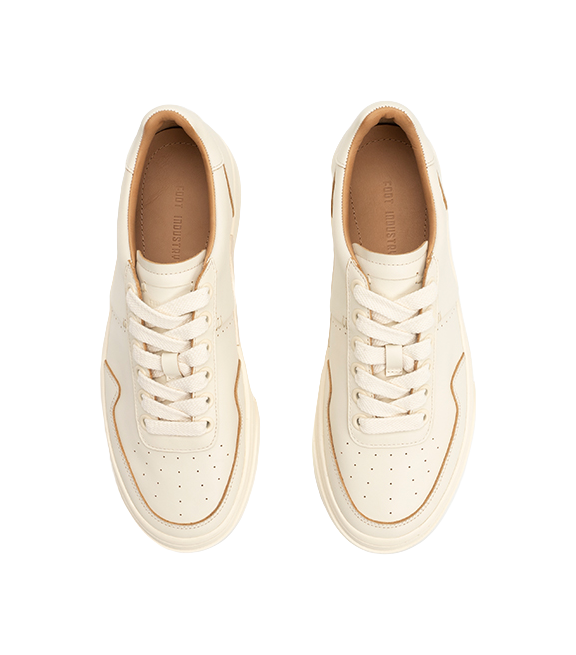 Antique white low-top skate shoes with woven laces and tan interior lining
