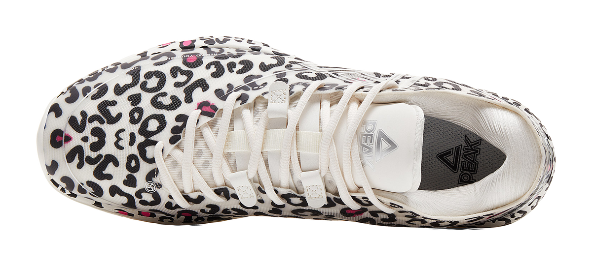 Lightweight basketball shoe, white fabric with black leopard print, laced front and tongue logo