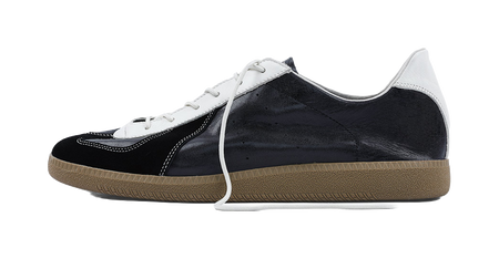 Black low-top training shoes with white laces and gum rubber sole