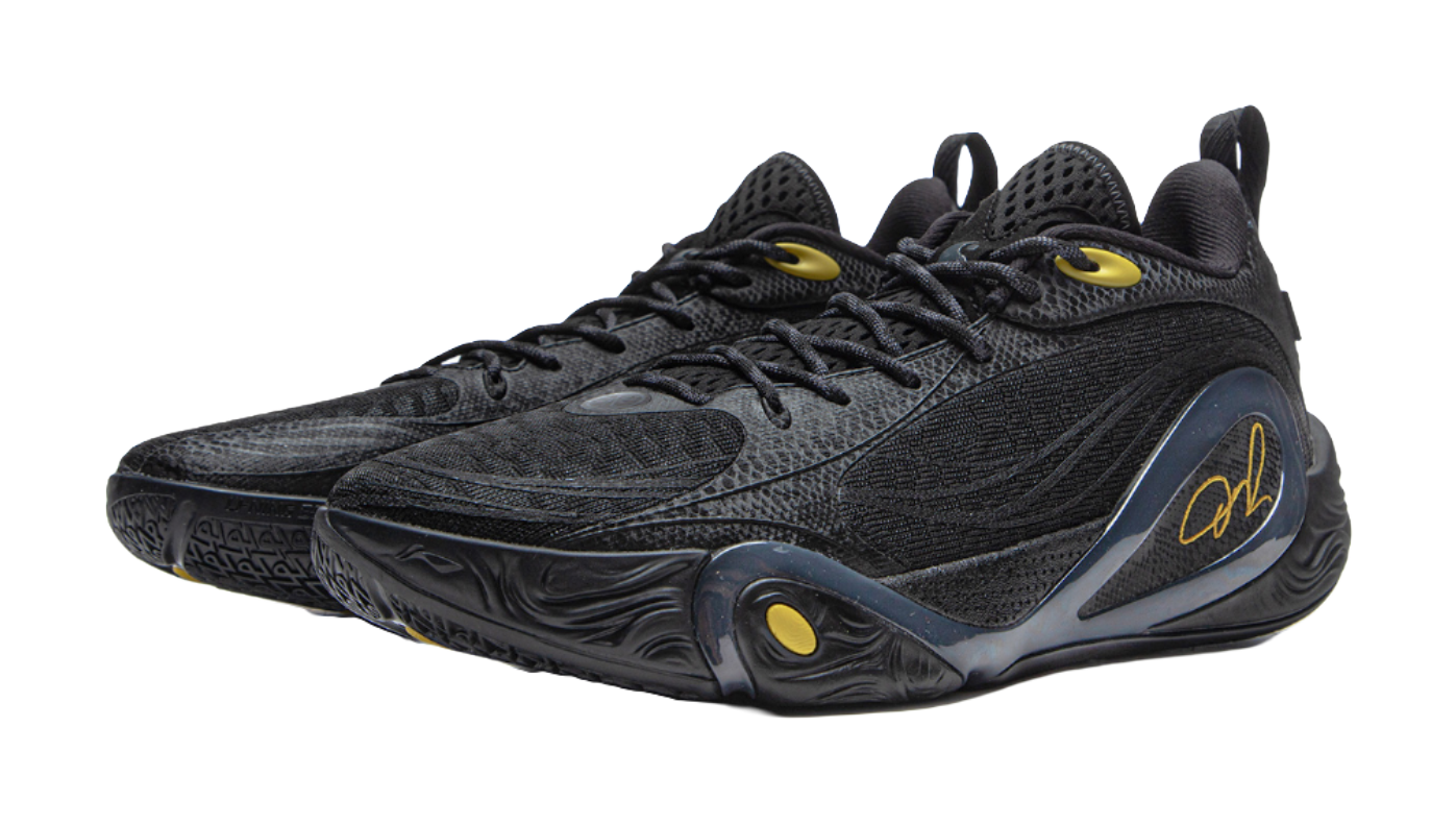 Black low-top basketball shoe with oval side detail and gold signature logo