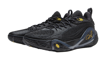 Black low-top basketball shoe with oval side detail and gold signature logo