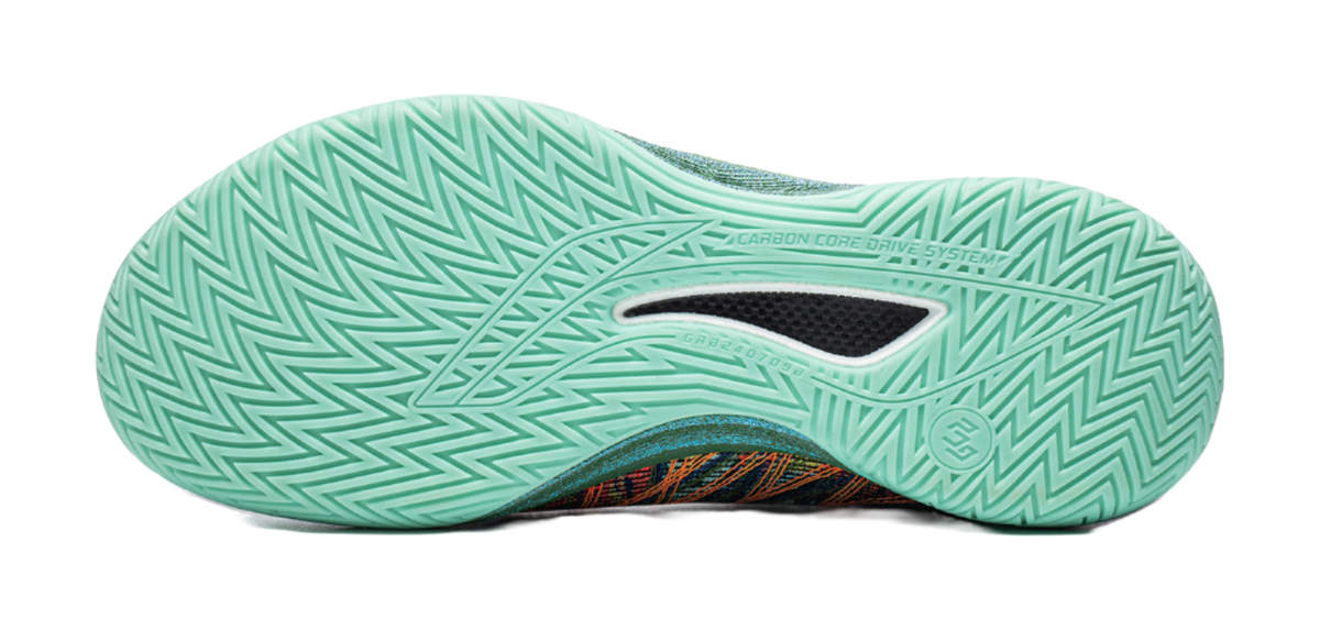 Low-top basketball shoe outsole in teal with Carbon Core tread pattern.