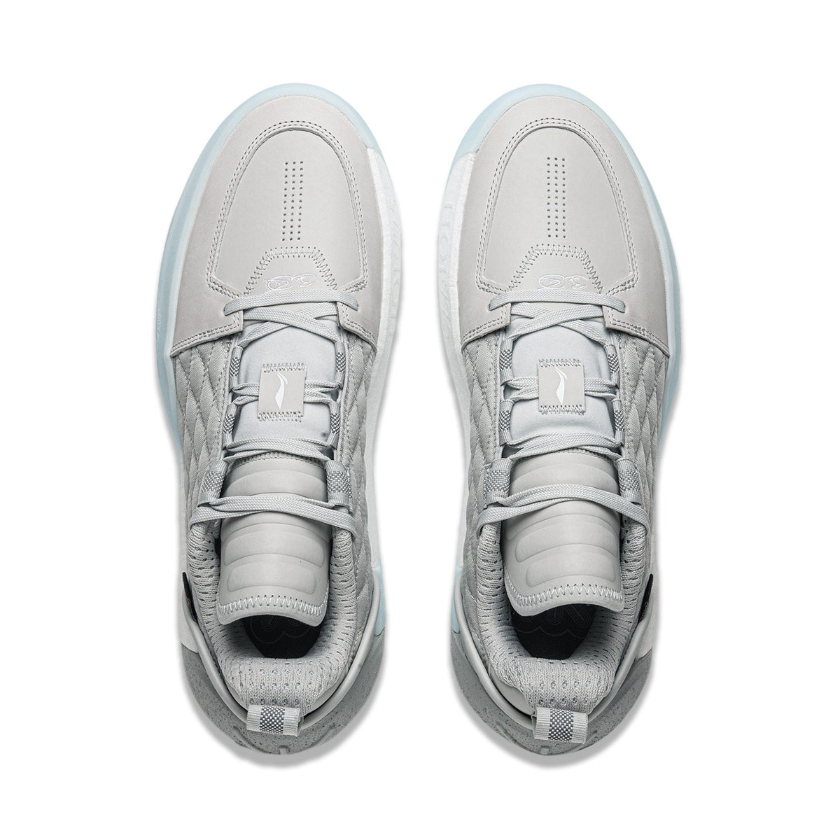Pair of men's grey basketball shoes, front view, with perforated toe and lace-up