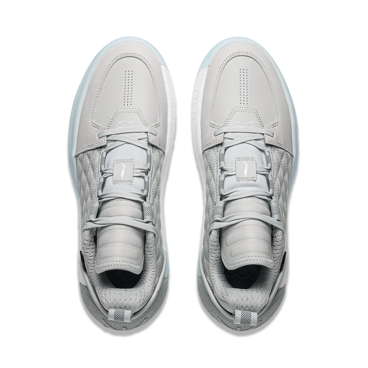 Pair of men's grey basketball shoes, front view, with perforated toe and lace-up