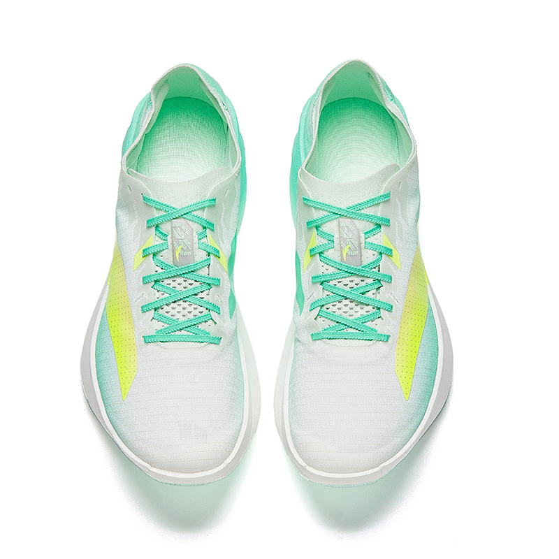 Lace-up racing shoes with white upper, green laces, and neon yellow logo accents