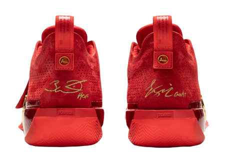 Red basketball shoes heel view with back tabs and printed heel label.
