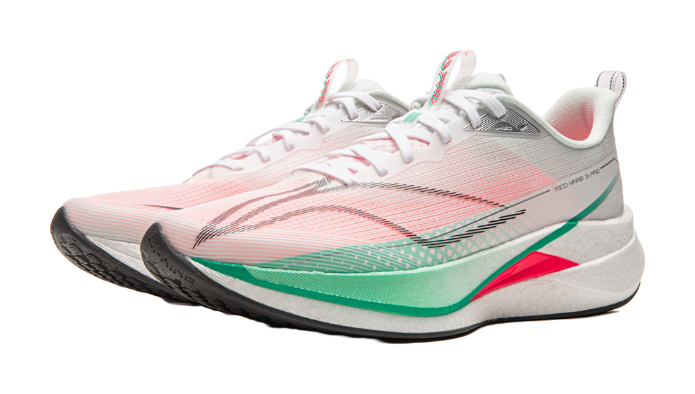 Running shoe three-quarter view in white and pink with laces, gray heel panel, green edge trim