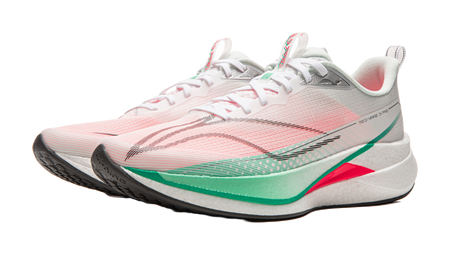 Running shoe three-quarter view in white and pink with laces, gray heel panel, green edge trim