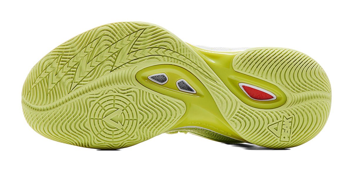 Light acid green basketball shoe outsole with deep tread, gray and red traction inserts
