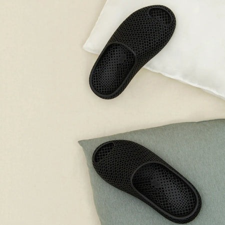 3D printed slippers, black footbeds shown with oval toe cutouts