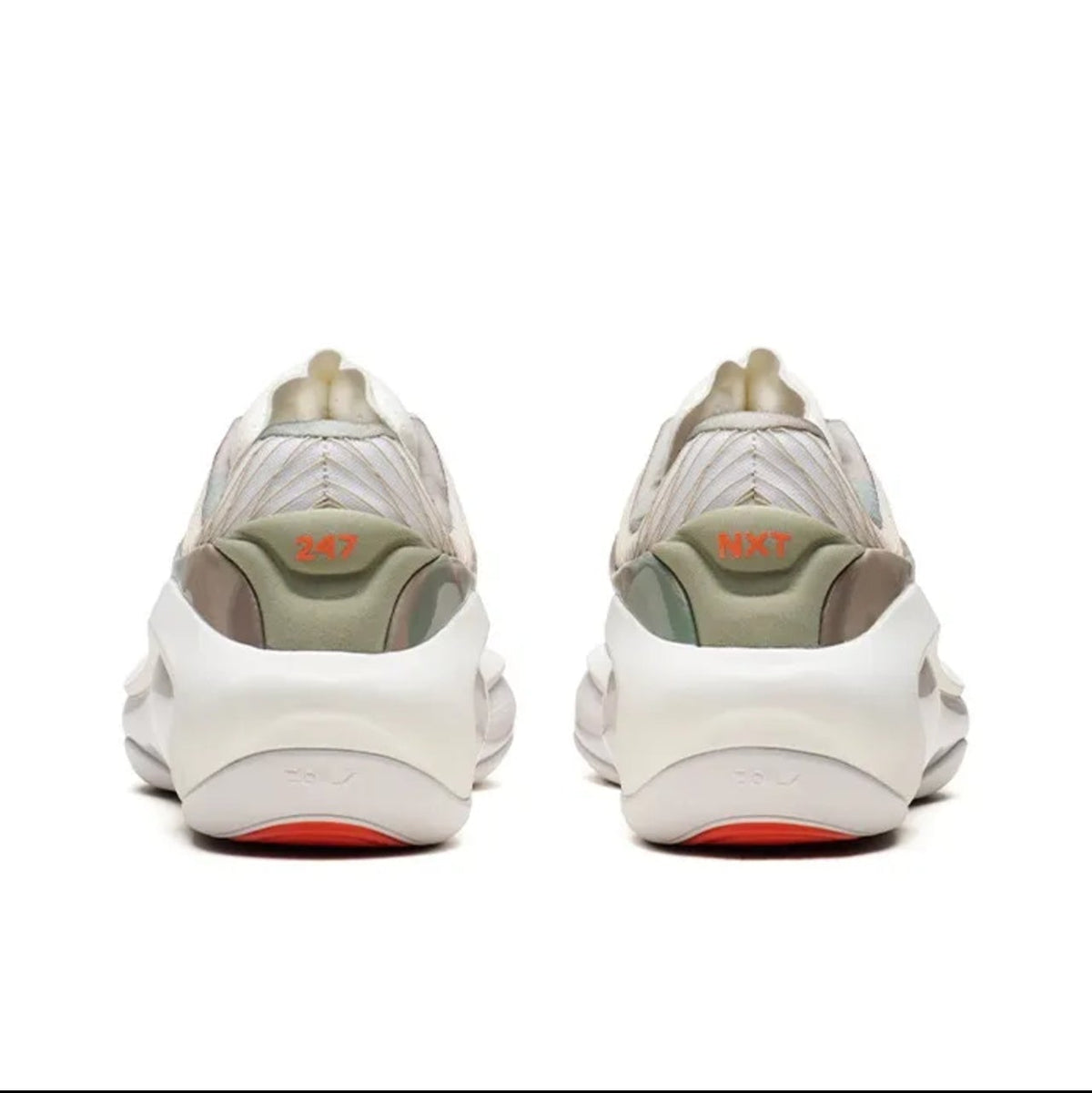 A pair of chunky low-top sneakers shown from the back, featuring a cream and light olive green upper with a thick white sole and a small orange accent near the heel.