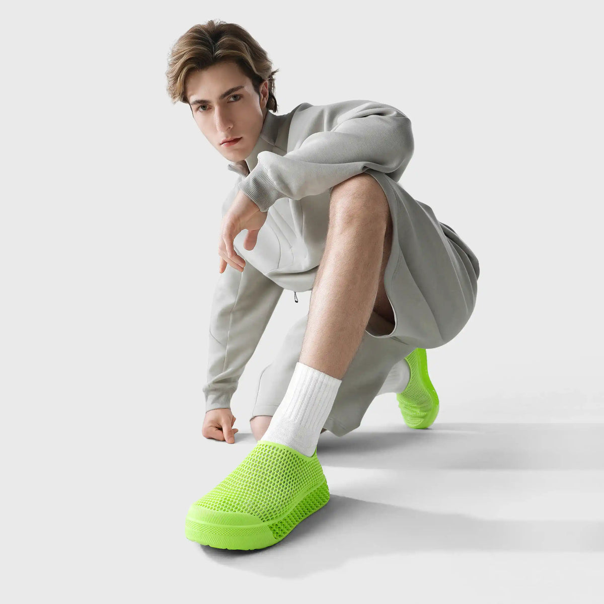 3D printed casual sneakers in lime green, perforated slip-on worn with white socks