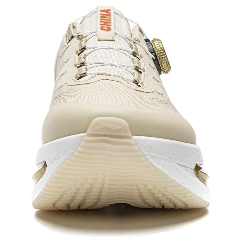 Khaki running shoe front view with BOA dial, thick sole, and gold side detail