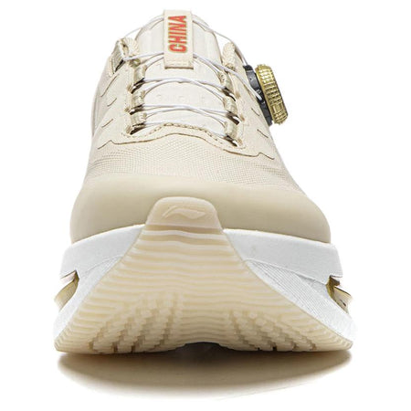 Khaki running shoe front view with BOA dial, thick sole, and gold side detail