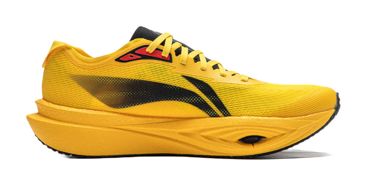 Chrome yellow low-top running shoe, side view, black graphic stripe and yellow laces.