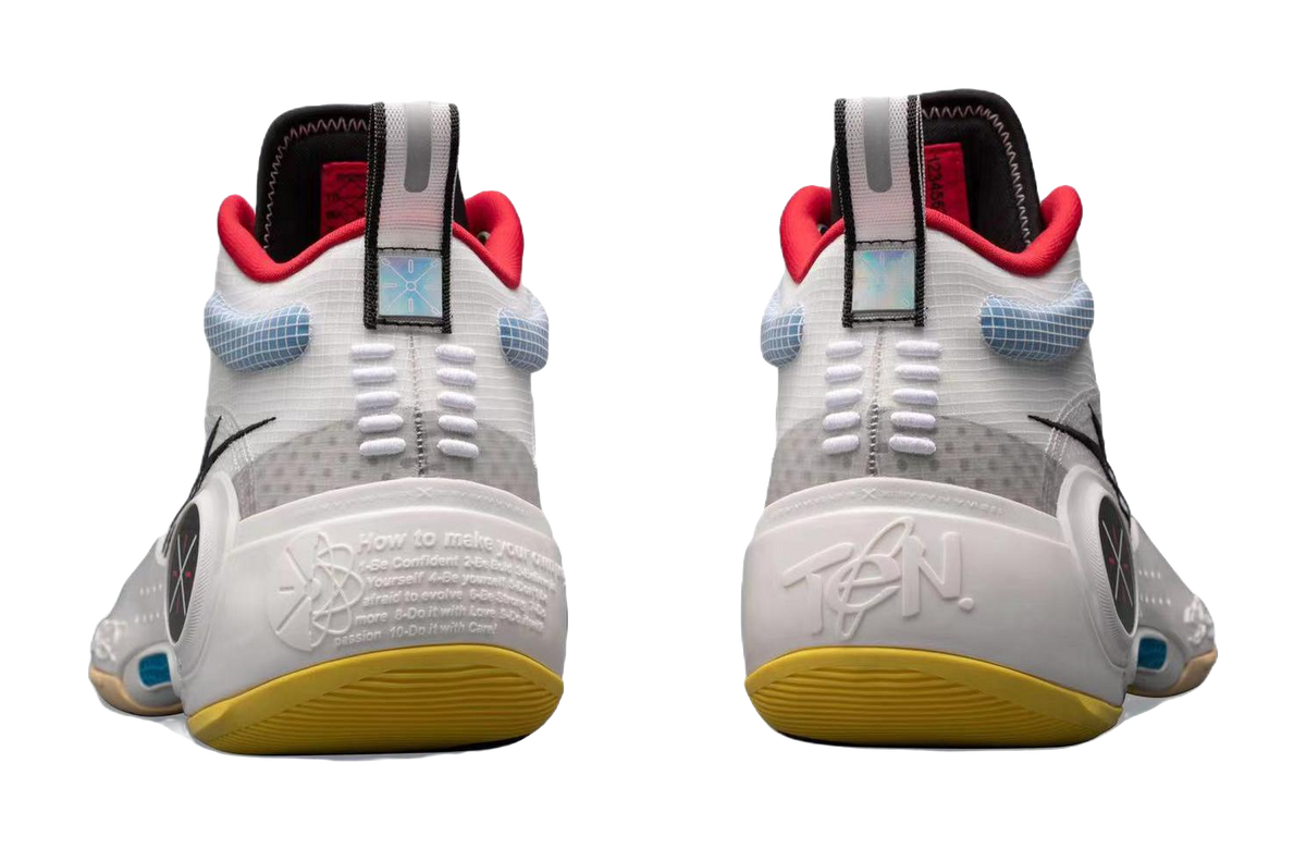 White mid-top basketball sneakers back view with red heel tabs and yellow outsole